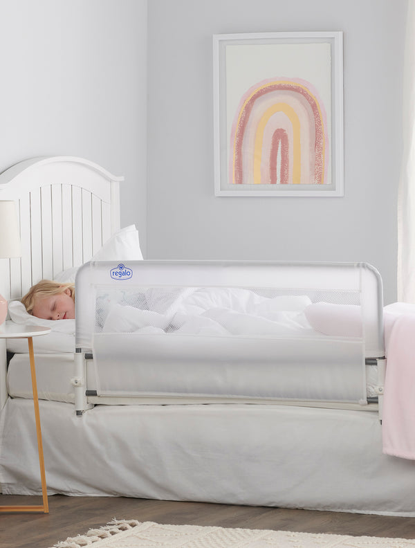 Child sleeps behind Easy Slide Bed Rail