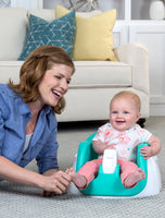 Baby smiles in My Little Seat® 2-in-1 Floor and Booster Seat - Teal