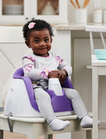 Child smiles in purple My Little Seat® 2-in-1 Floor and Booster Seat