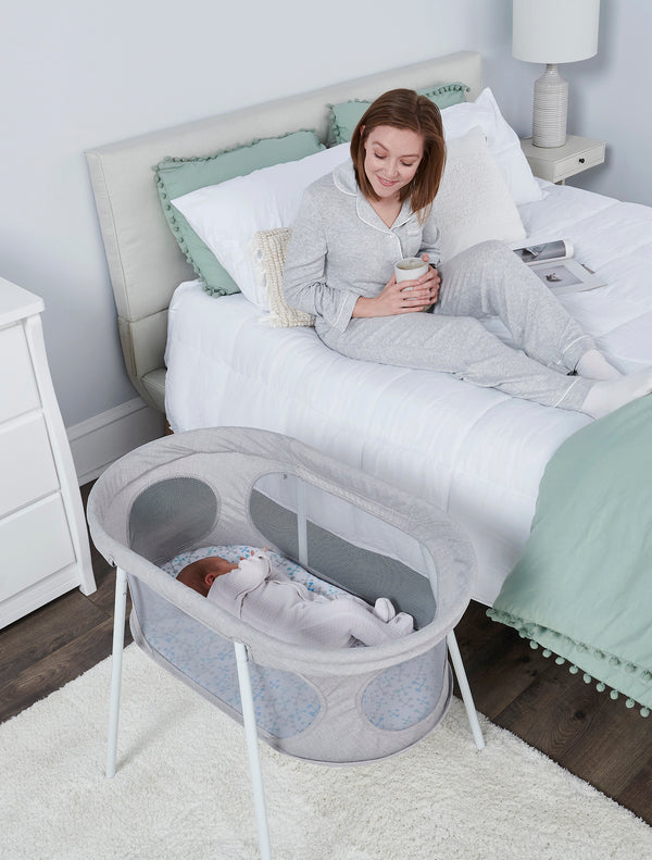 Baby sleeps in the Baby Basics™ Infant Bassinet