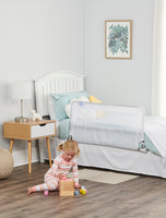 Child plays on floor in front of HideAway Bed Rail