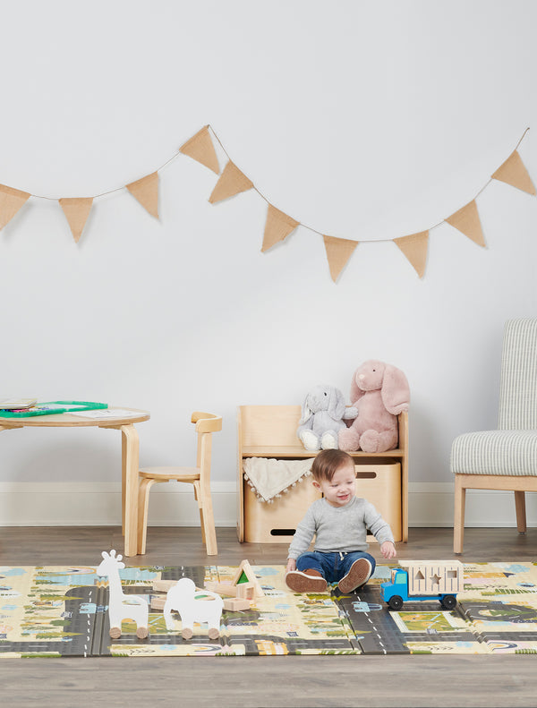 Child plays on My Around Town Play Mat®