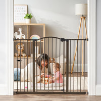 Mom playing with baby behind gate