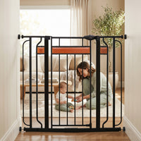 Mom and baby playing behind safety gate in a living room