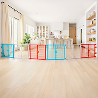 Family in kitchen while with the plastic safety gate as the focus