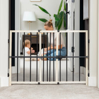 Mom and baby playing behind safety gate
