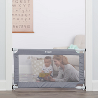 Mom and toddler reading a book behind safety gate