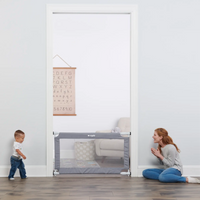 toddler walking to mom in front os safety gate