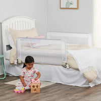 Child playing on floor in front of bed
