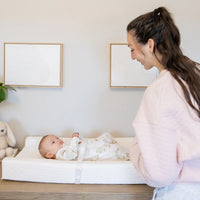 Mom looking at baby on the chanigng pad 