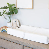 Infant changing pad on dresser in nursery