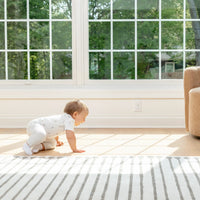 Baby crawling in front of outlet plugs