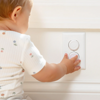 Baby touching outlet plugs