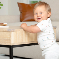 Baby standing by coffee table with Clear Corner Cushion on corner
