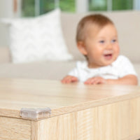 Close-up of Clear Corner Cushion with baby in the background