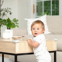 Corner Cushion on coffee table with baby standing by