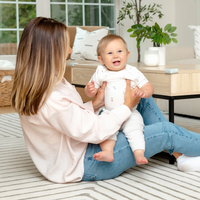 Corner Cushion on coffee table with mom and baby playing in front of it