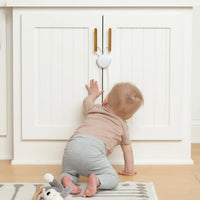 Toddler crawling toward cabinet with Flex lock on it