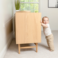 Toddler standing up on dresser with anchor straps attached to it