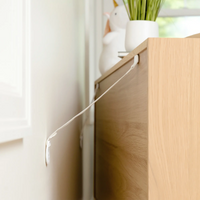 Close-up of furniture straps attached to the dresser