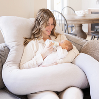 Mom feeding baby while using maternity pillow