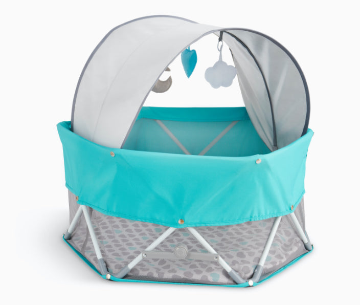 Product photo of teal My Play Baby Bassinet against a white background