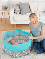 Baby looks up from My Play Baby Portable Infant Bassinet
