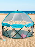 Child plays inside Eight Panel My Play® Deluxe Portable Play Yard at the beach
