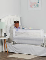 Child smiles in bed behind Swing Down Bed Rail
