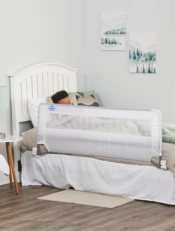 Child sleeps behind Extra Long Swing Down Bed Rail