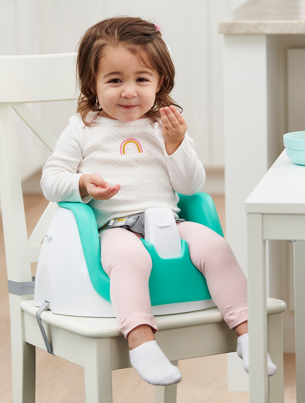 Child eats in teal My Little Seat® 2-in-1 Floor and Booster Seat