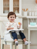 Child eats in My Little Seat® 2-in-1 Floor and Booster Seat in Gray