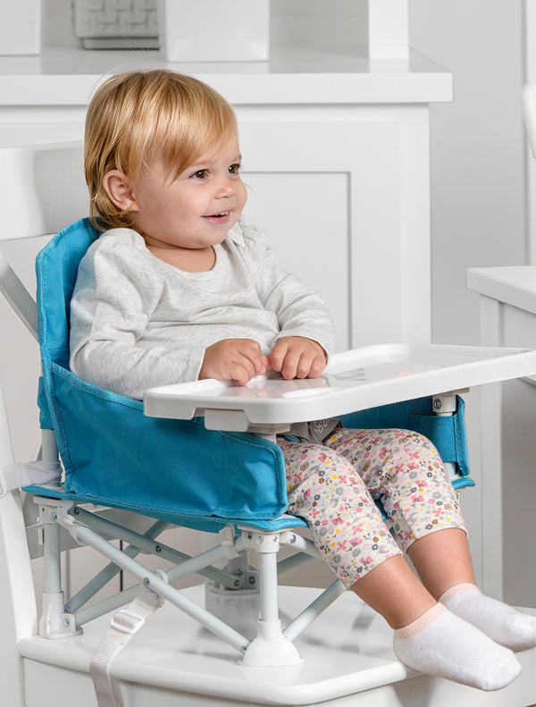 Child seated in My Chair™ Portable Booster Seat
