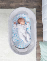 Baby sleeps in the Baby Basics™ Infant Bassinet