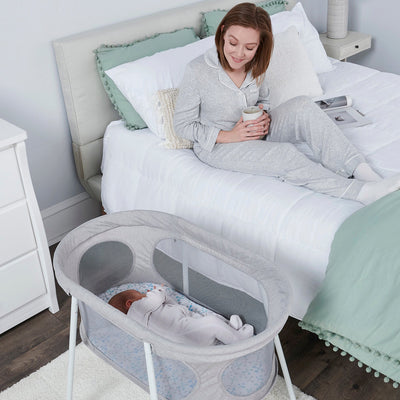 Baby sleeps in the Baby Basics™ Infant Bassinet
