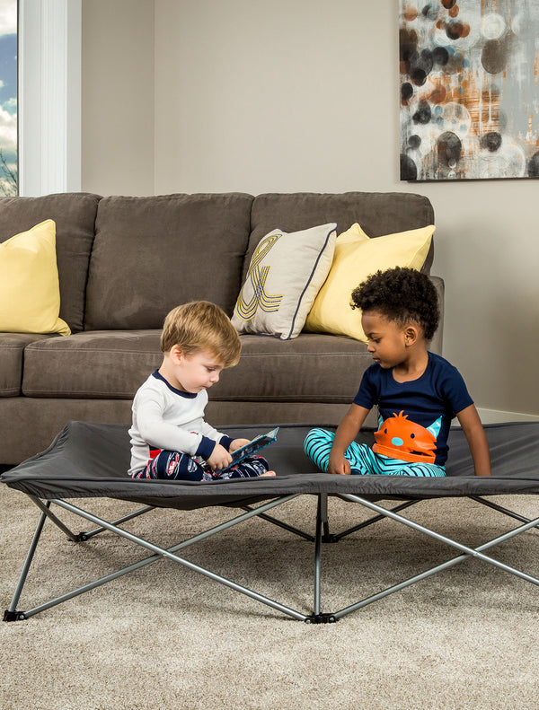 Children sitting on Gray Extra Long My Cot® Portable Toddler Bed™