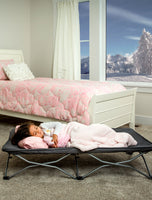 Child sleeps on Gray My Cot® Portable Toddler Bed™