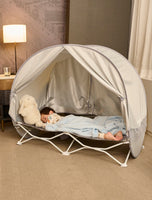 Child sleeping in My Cot® with Canopy Portable Toddler Bed™