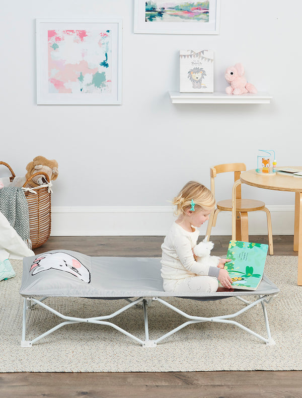Child sits on Gray Polar Bear My Cot Pals Portable Toddler Bed