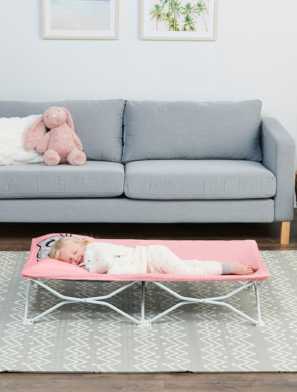 Child sleeps on Pink Kitty My Cot® Pals Portable Toddler Bed