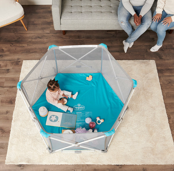 Top down view of 6-panel My Play Portable Play Yard® (white) on rug